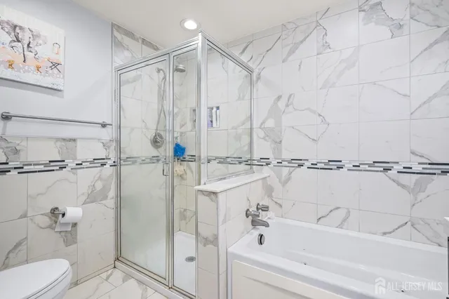 a bathroom with a bathtub and a shower