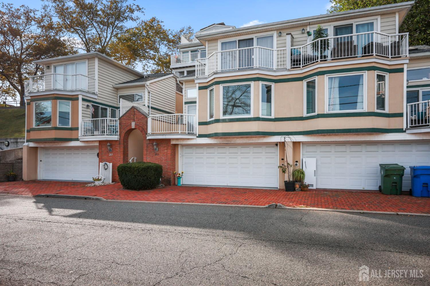 265 Front Street Perth Amboy, NJ 08861 - Photo 4 of 38 a front view of a house with a yard and garage