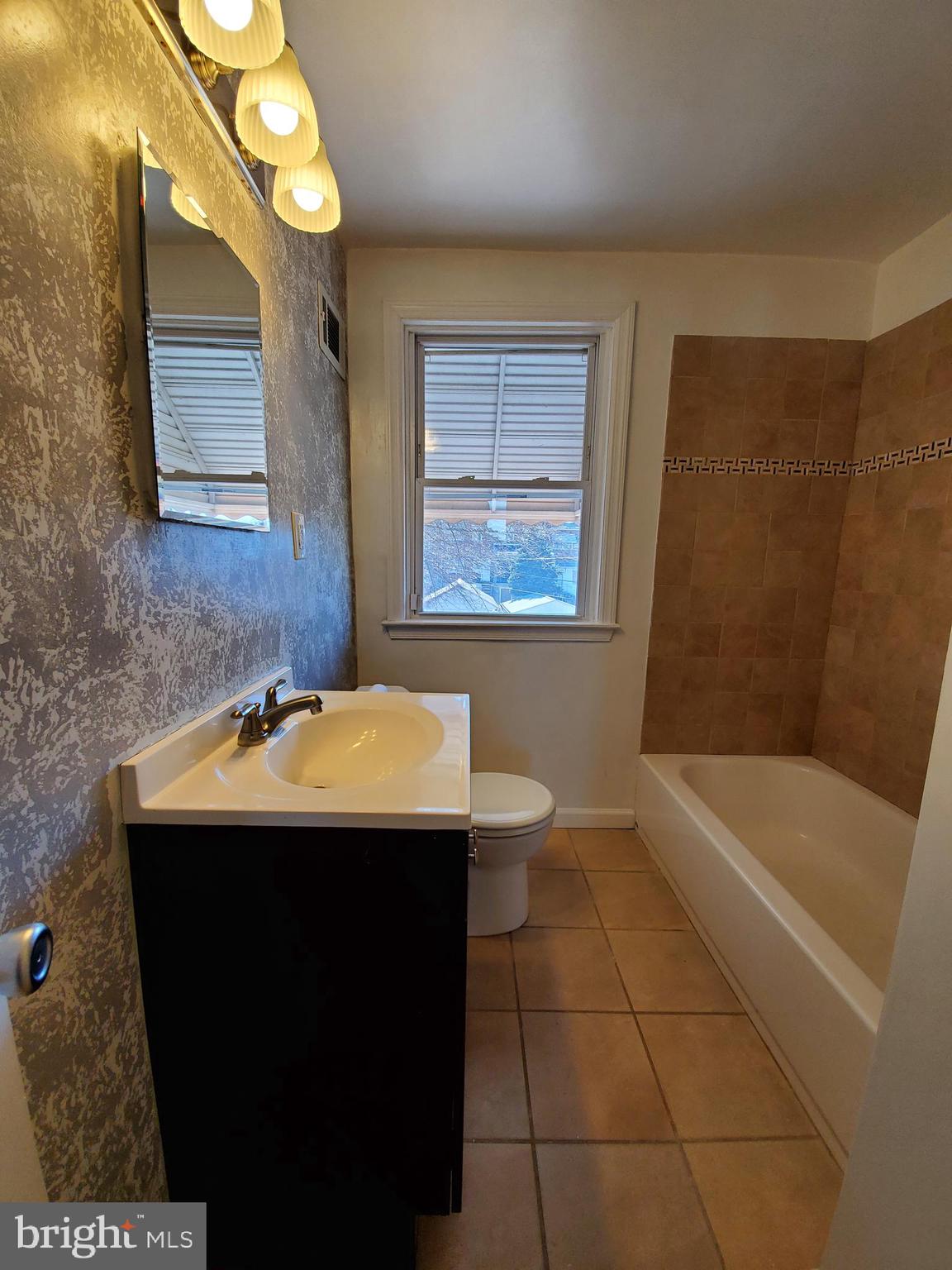 309 Arden Road West Baltimore, MD 21225 - Photo 10 of 16 a bathroom with a sink a toilet and bathtub