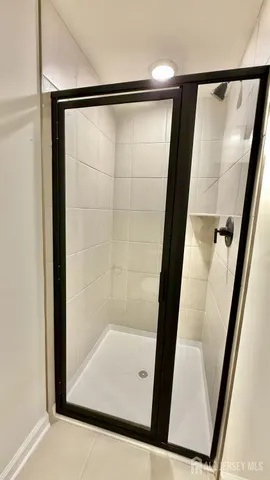 a bathroom with a glass shower door
