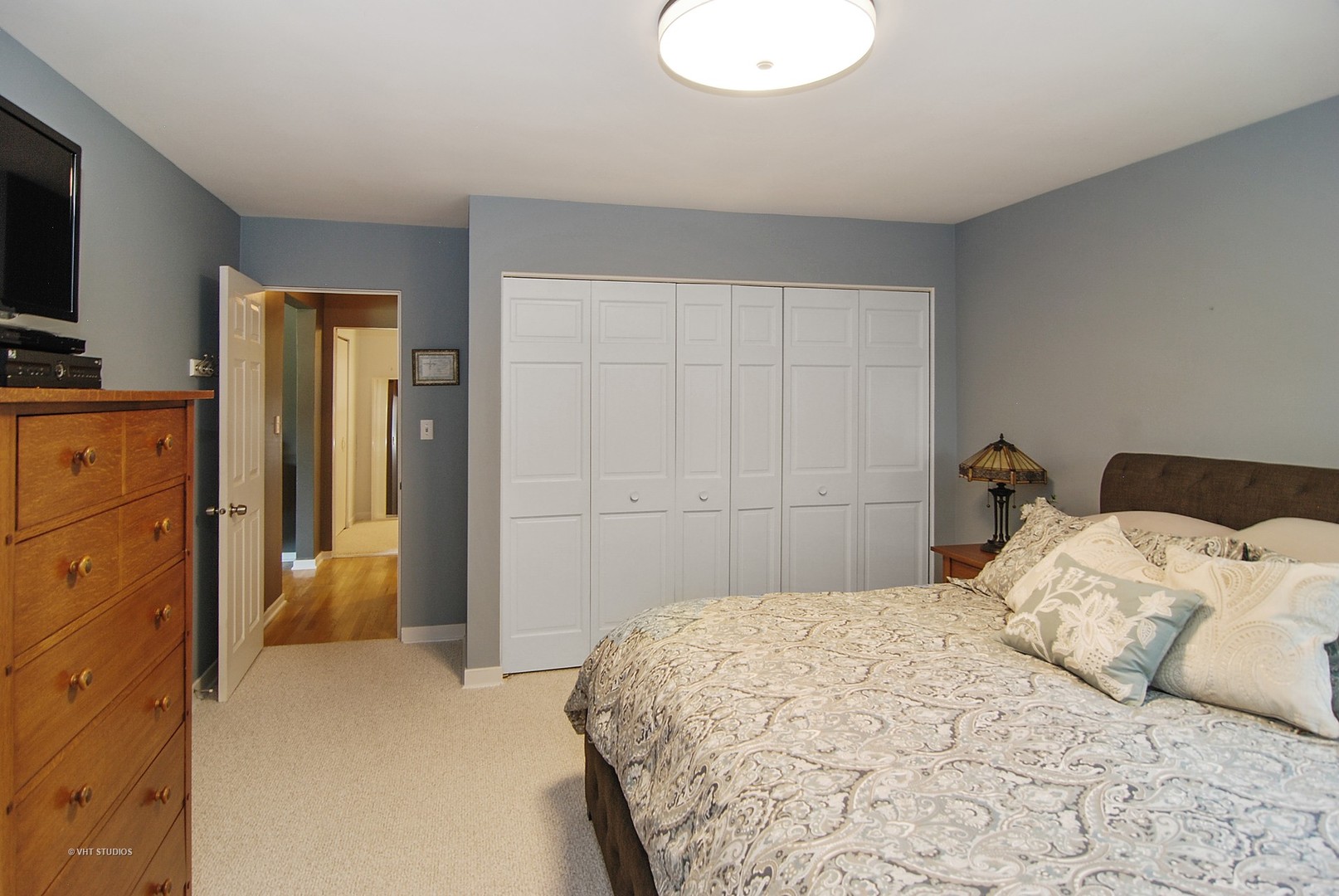 499 Kent Road Riverside, IL 60546 - Photo 16 of 28 a bedroom with a bed and a flat tv screen on dresser