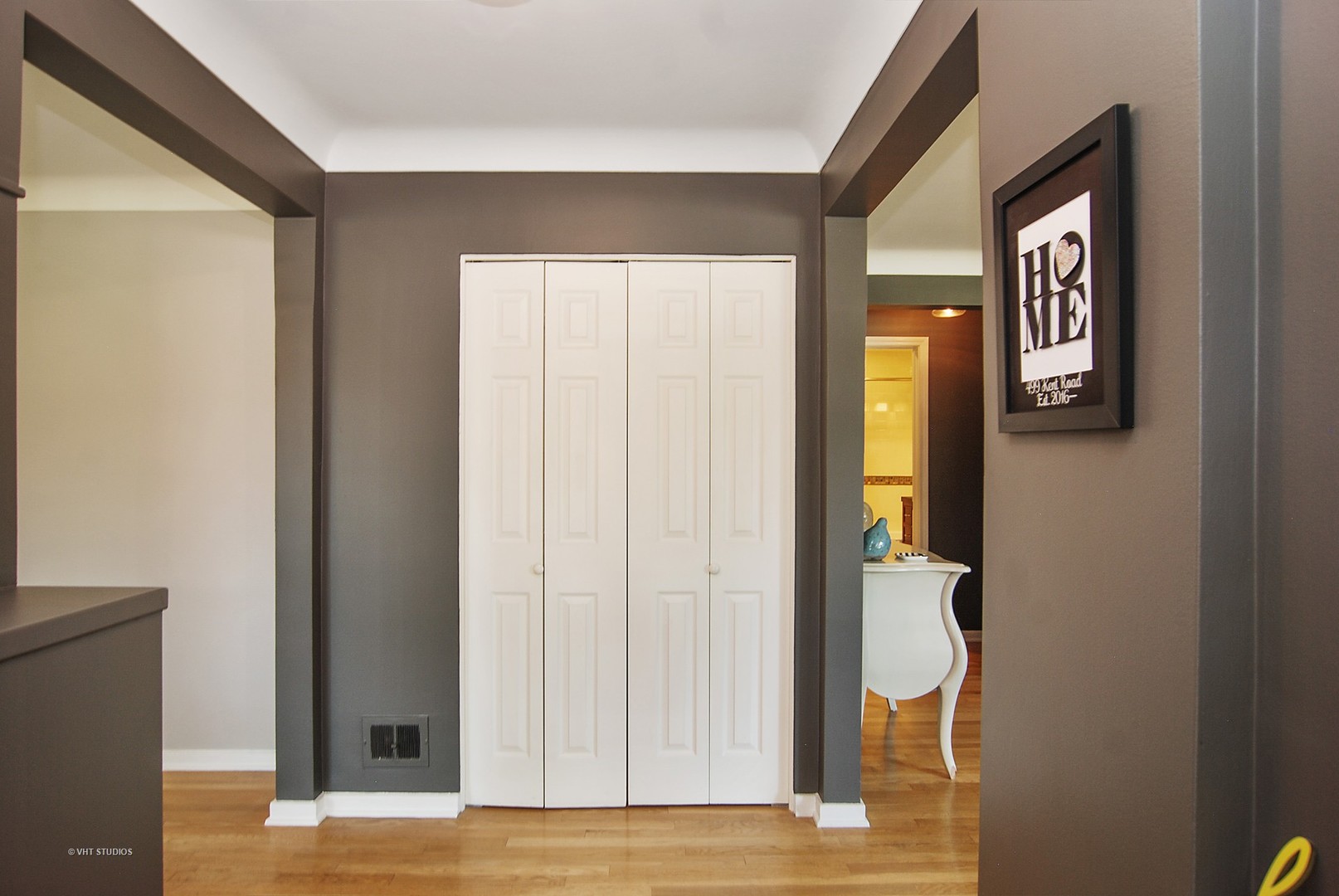 499 Kent Road Riverside, IL 60546 - Photo 2 of 28 a view of a hallway with wooden floor and a cabinet