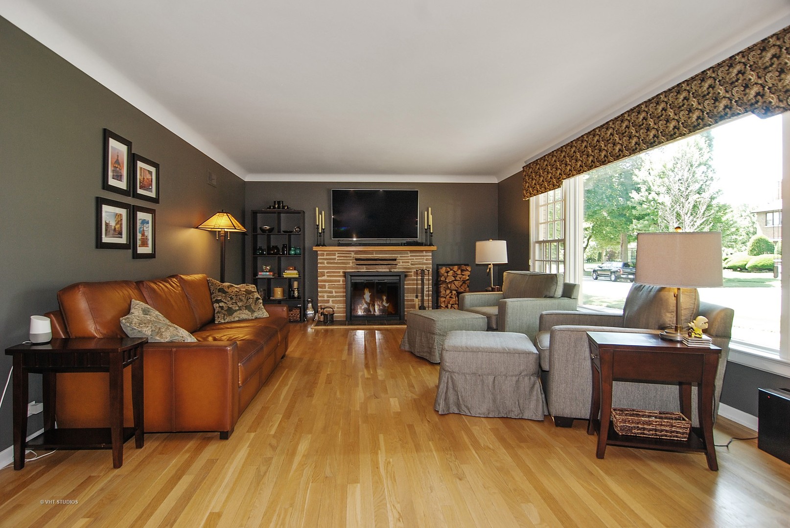 499 Kent Road Riverside, IL 60546 - Photo 5 of 28 a living room with furniture a fireplace and a flat screen tv