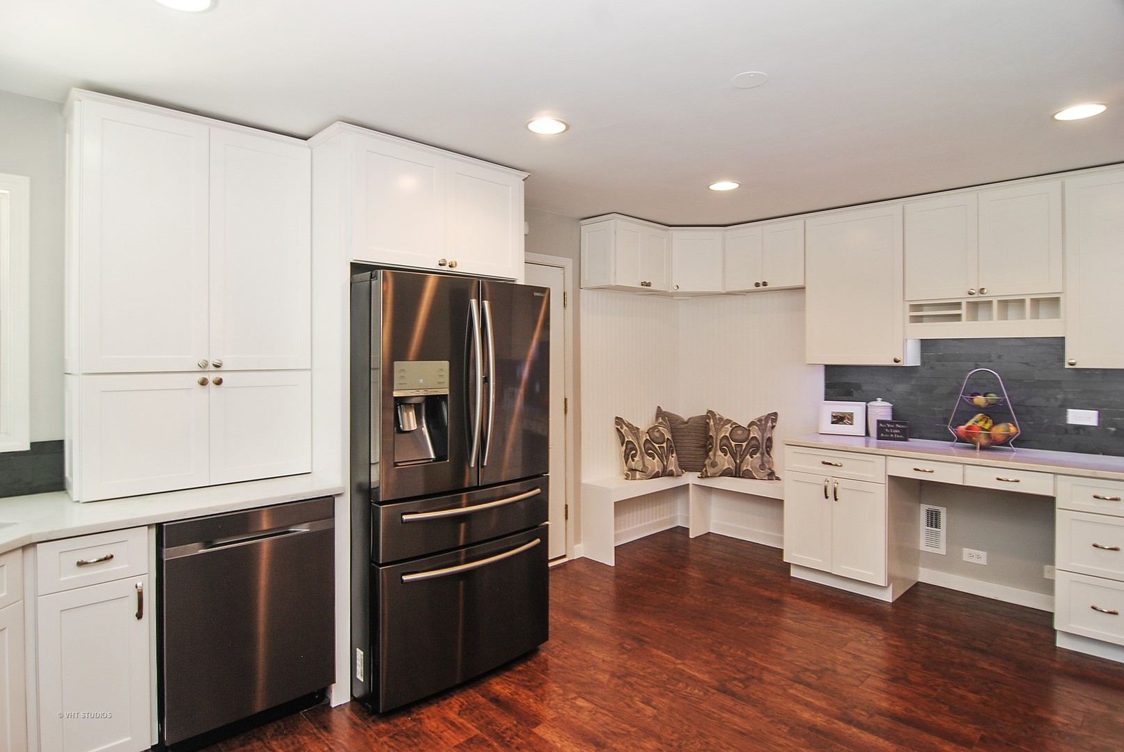 499 Kent Road Riverside, IL 60546 - Photo 9 of 28 a kitchen with a refrigerator stainless steel appliances wooden floor and cabinets