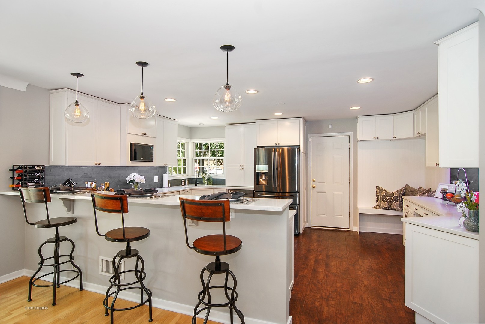 499 Kent Road Riverside, IL 60546 - Photo 10 of 28 a kitchen with stainless steel appliances granite countertop a refrigerator a stove top oven a dining table and chairs with wooden floor