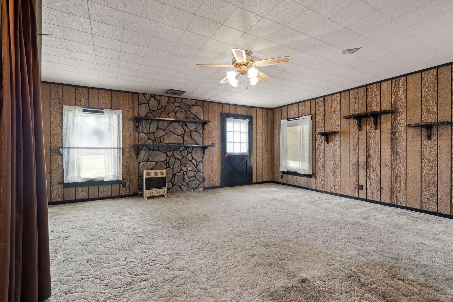 7976 Susan Road Millington, TN 38053 - Photo 11 of 25 an empty room with windows and chandelier fan
