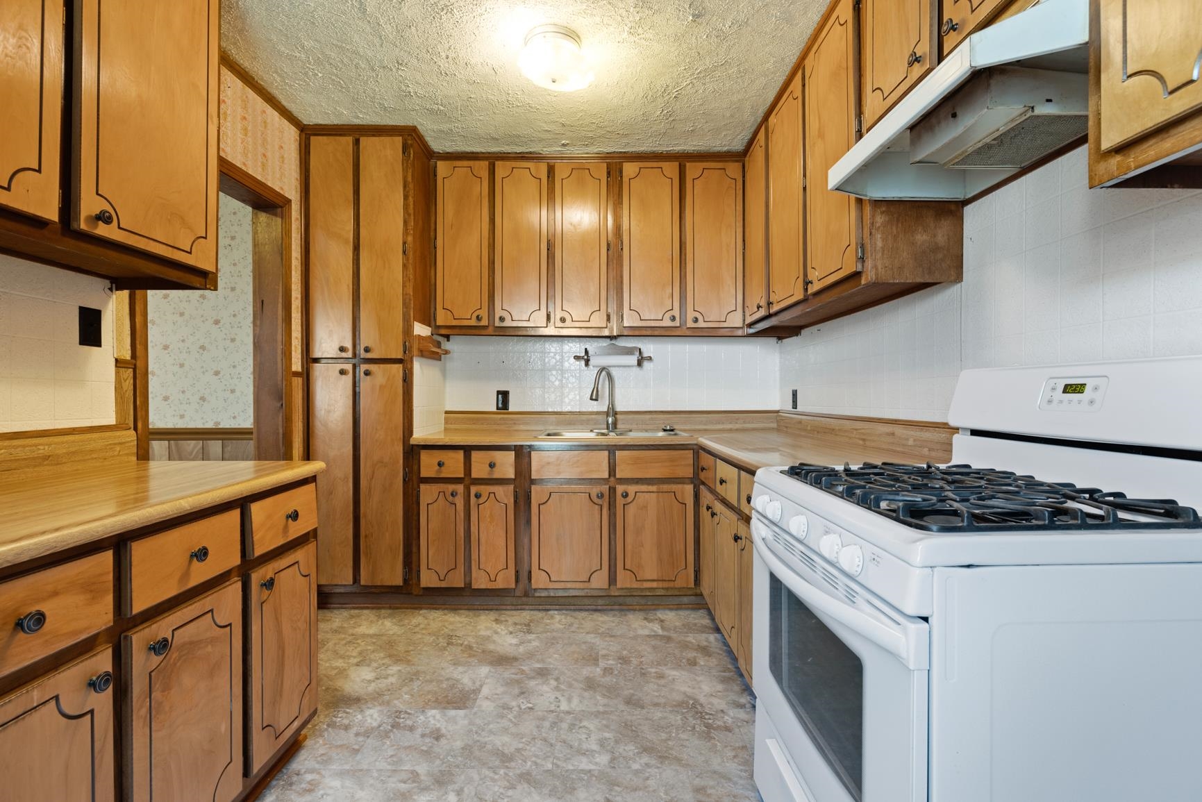7976 Susan Road Millington, TN 38053 - Photo 9 of 25 a kitchen with stainless steel appliances granite countertop a stove a sink and a refrigerator