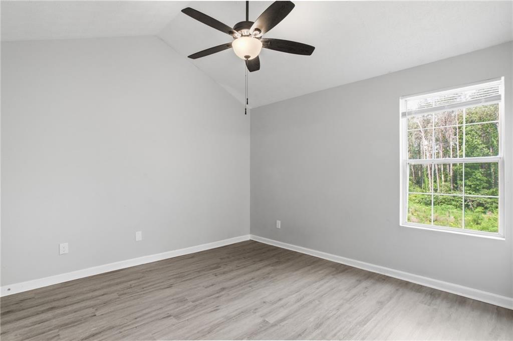 5855 Crescent Ridge Court Lithonia, GA 30058 - Photo 20 of 46 a view of an empty room with wooden floor and a window