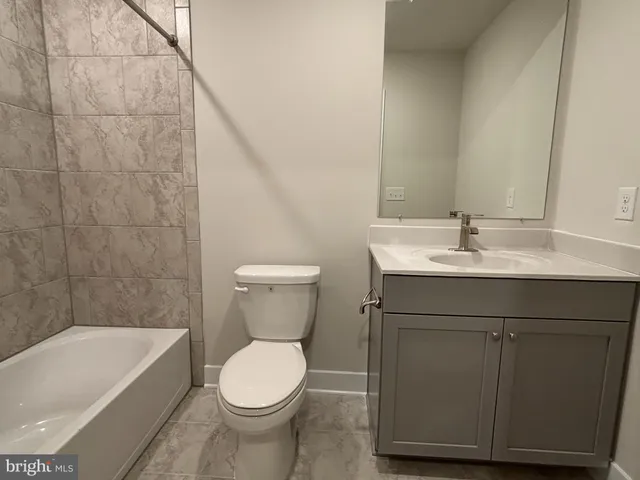a bathroom with a sink toilet and bathtub