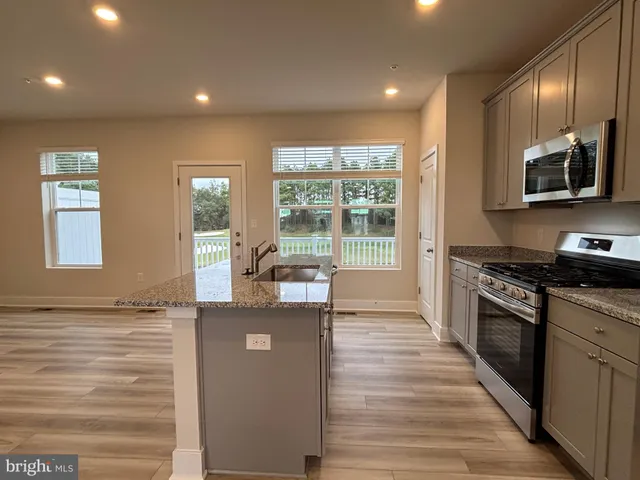 a kitchen with stainless steel appliances granite countertop a stove and a sink
