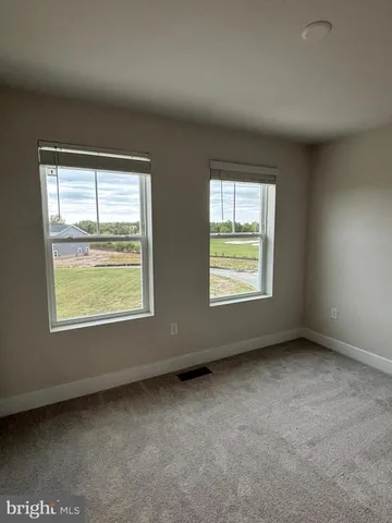 a view of a wooden deck and a yard with wooden fence