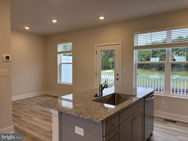 a kitchen with granite countertop a sink and a window