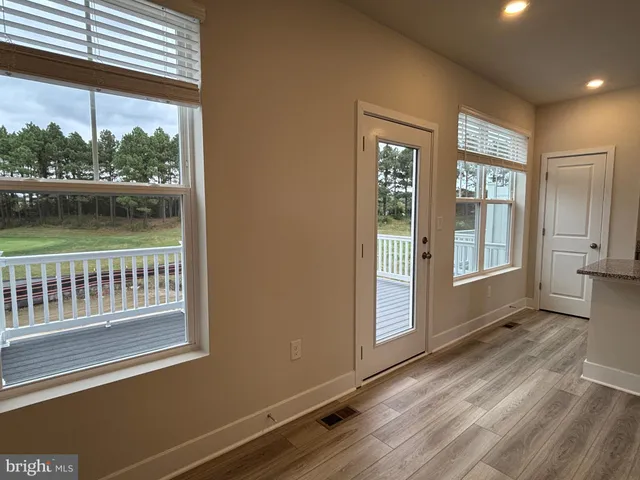 a view of a room with balcony and floor to ceiling windows