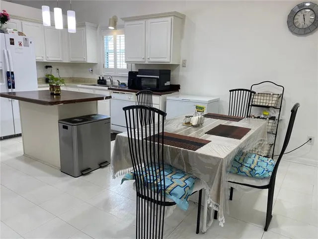 a kitchen with granite countertop a sink appliances cabinets and counter space