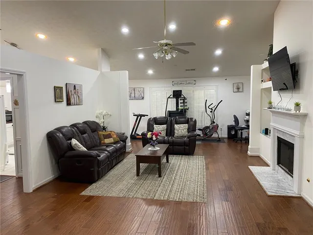 a living room with furniture and a wooden floor