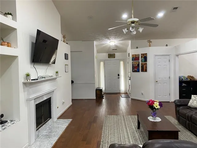 a living room with furniture a fireplace and a flat screen tv