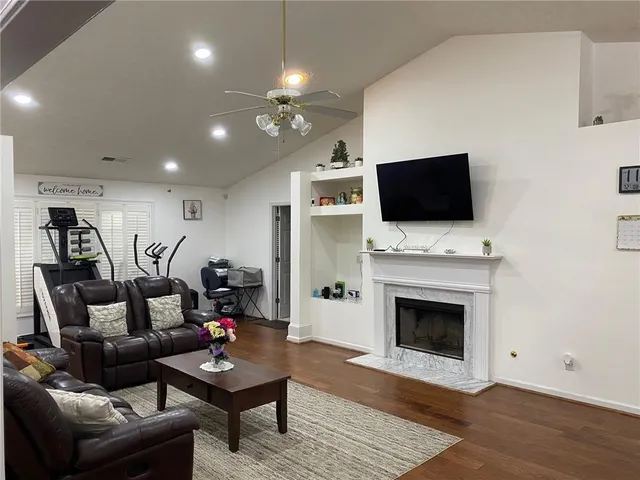 a view of a dining room with furniture wooden floor and a chandelier