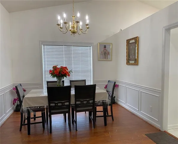 a view of a dining room with furniture and chandelier