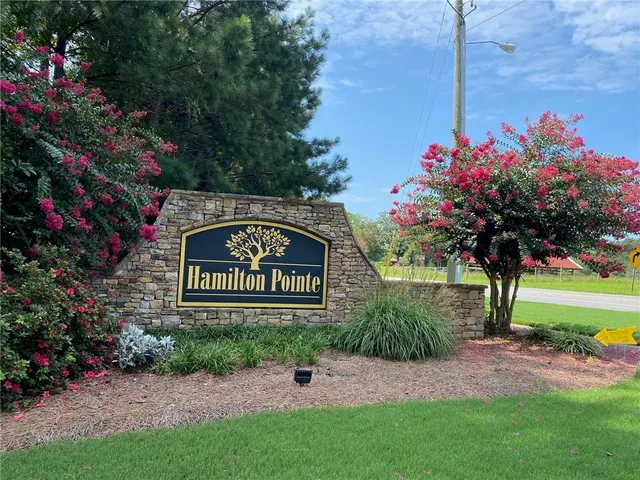 a sign that is sitting in front of flowers