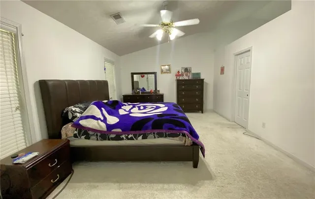 a bedroom with a bed and a dresser