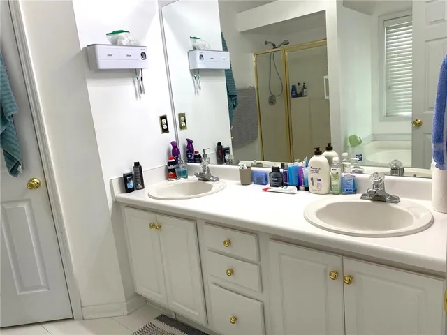 a bathroom with a double vanity sink and a mirror