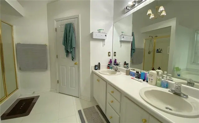 a bathroom with a tub a sink and a shower