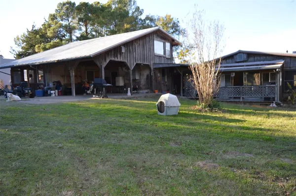a view of a house with backyard and sitting area