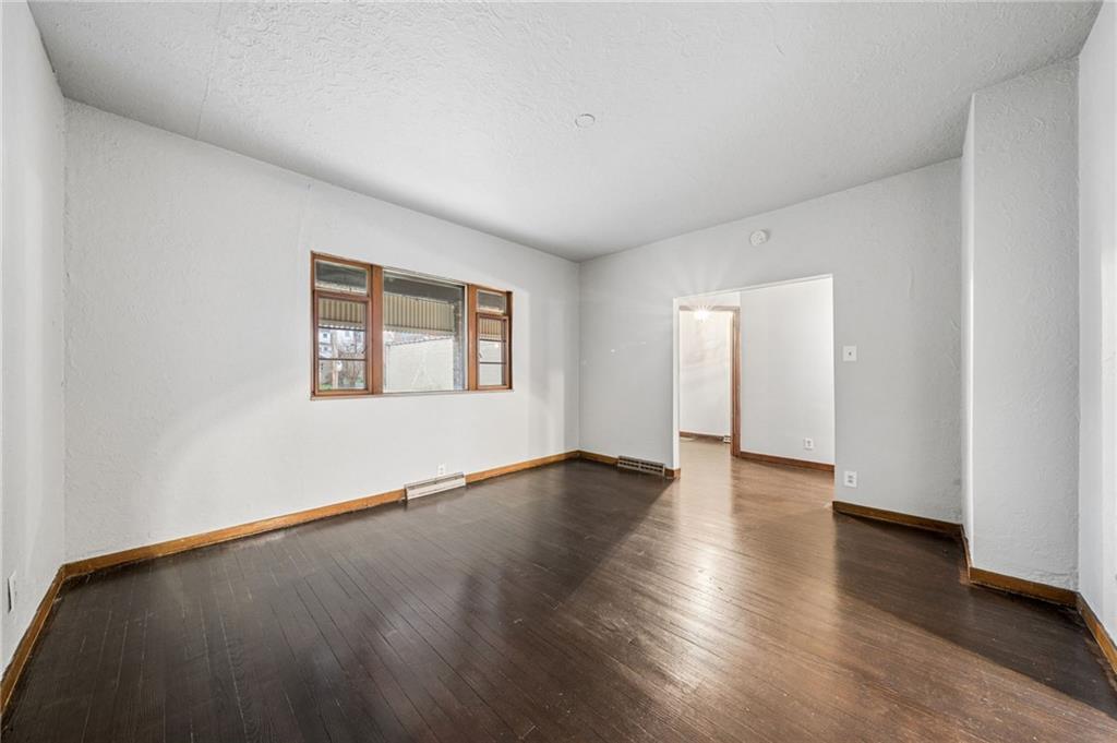 620 Broadway Avenue McKees Rocks, PA 15136 - Photo 5 of 18 an empty room with wooden floor and windows