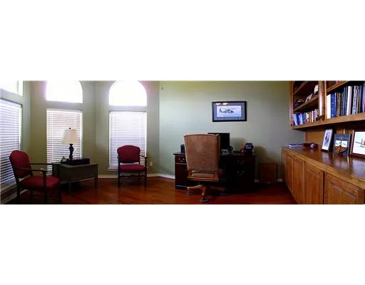 a living room with furniture and a bookshelf