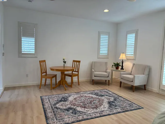 a living room with furniture and a rug