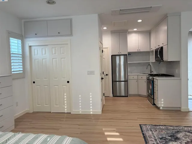 a view of a kitchen with stainless steel appliances granite countertop a refrigerator and a sink