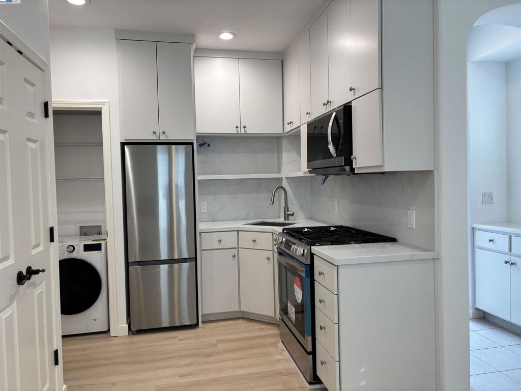 3089 Sweetviolet Drive San Ramon, CA 94582 - Photo 4 of 13 a kitchen with stainless steel appliances granite countertop a stove a refrigerator and a microwave