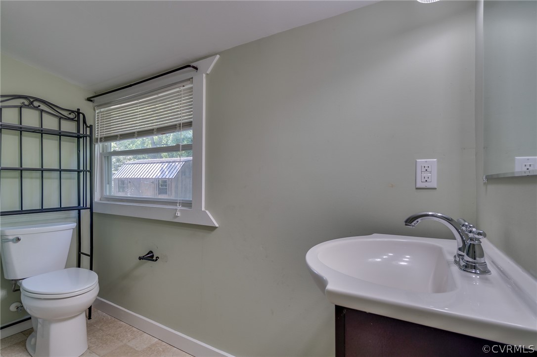 1429 Fredericks Hall Road Bumpass, VA 23024 - Photo 20 of 30 a bathroom with a sink toilet and a mirror