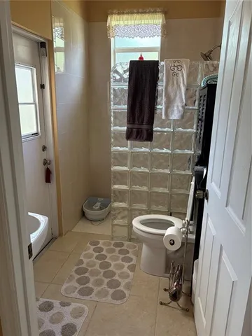 a bathroom with a toilet and a shower