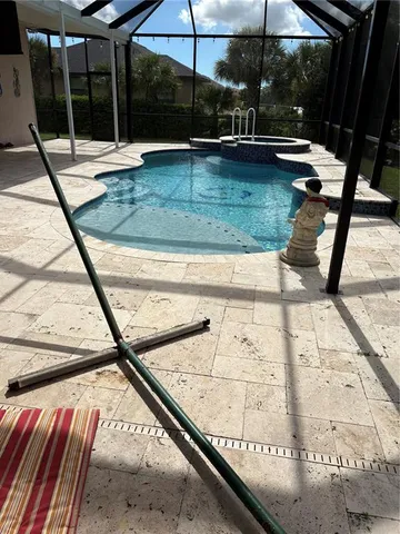 a view of swimming pool with a bench in patio