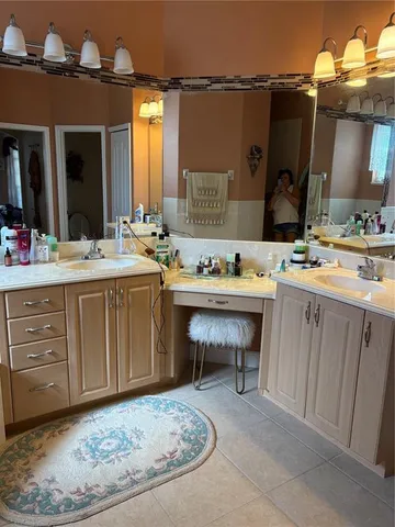 a room with cabinets furniture and a chandelier