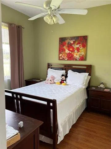 a bed sitting in a bedroom next to a window