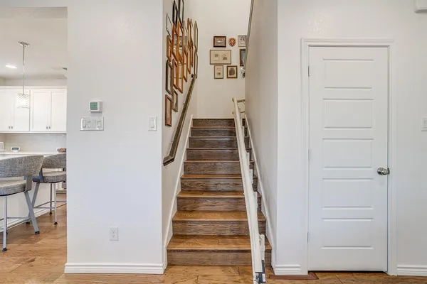 a view of entryway and hall with wooden floor
