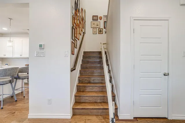 a view of entryway and hall with wooden floor