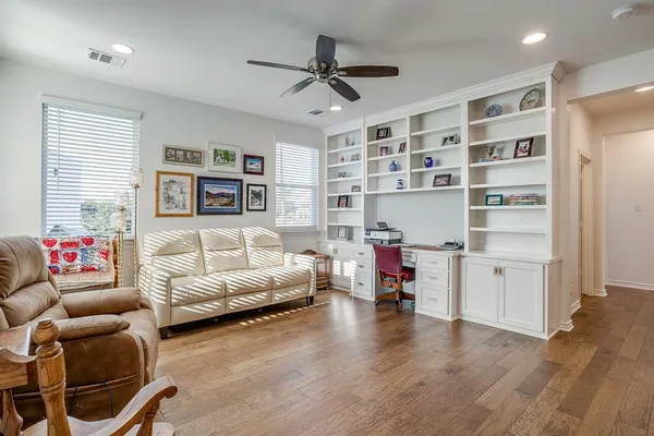 a living room with furniture and a wooden floor