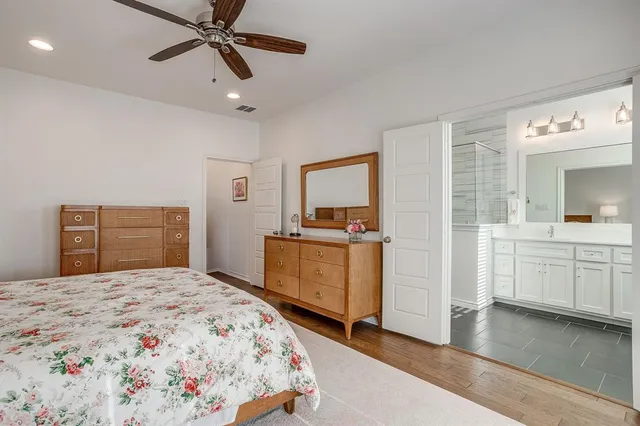 a bedroom with a large bed and a mirror