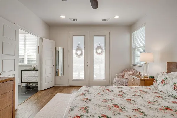 a bedroom with a bed and large windows