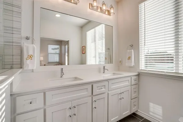 a bathroom with a sink double vanity and a mirror