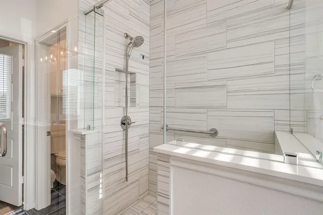 a bathroom with a granite countertop shower and a sink
