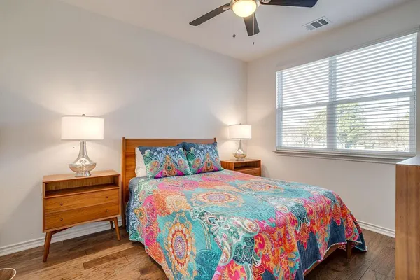 a bedroom with a bed a lamp and a window