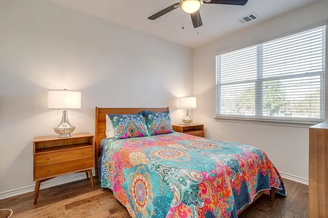 a bedroom with a bed a lamp and a window