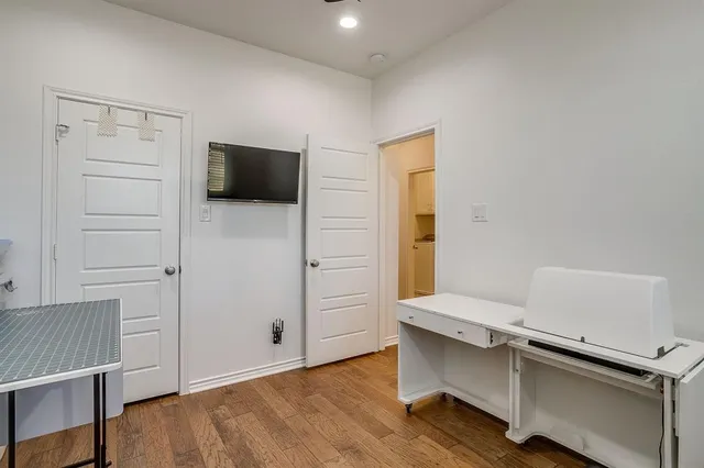 a room with a wooden floor and white walls