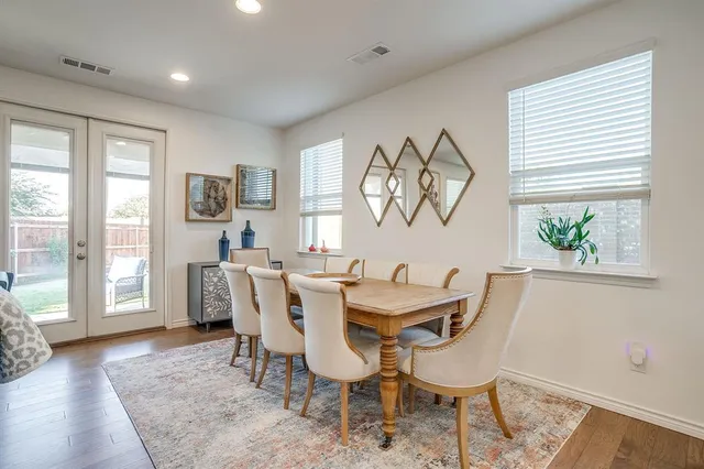 a view of a dining room with furniture and a window