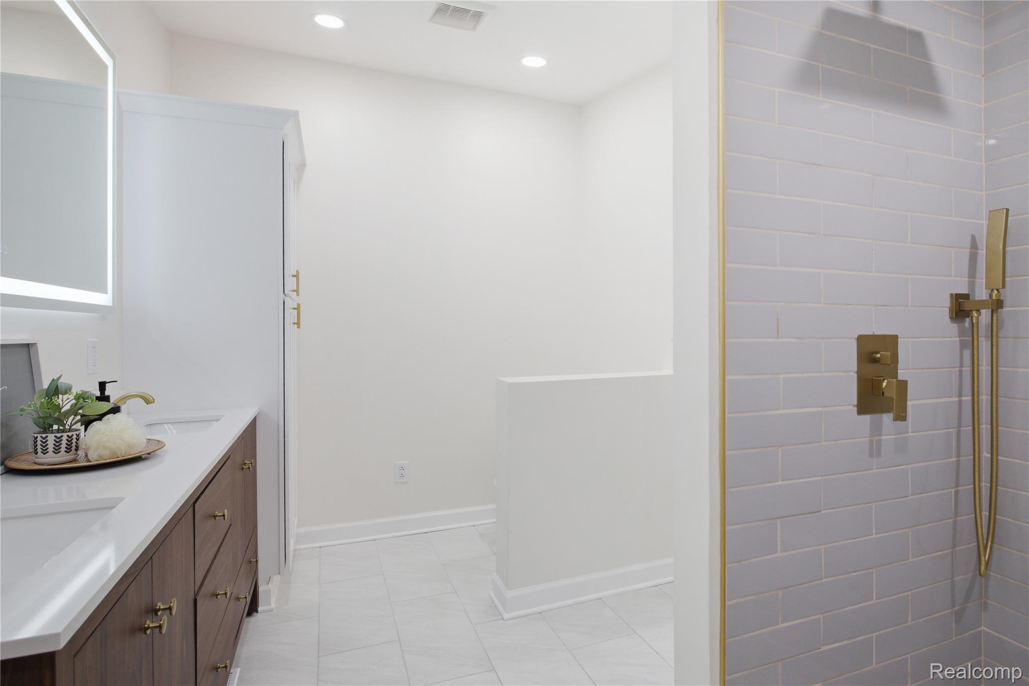 5350 List Road Grass Lake, MI 49240 - Photo 28 of 71 Bathroom featuring double vanity, tiled shower, and recessed lighting