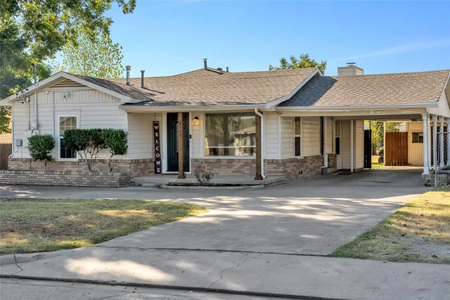 a view of a house with swimming pool and a yard